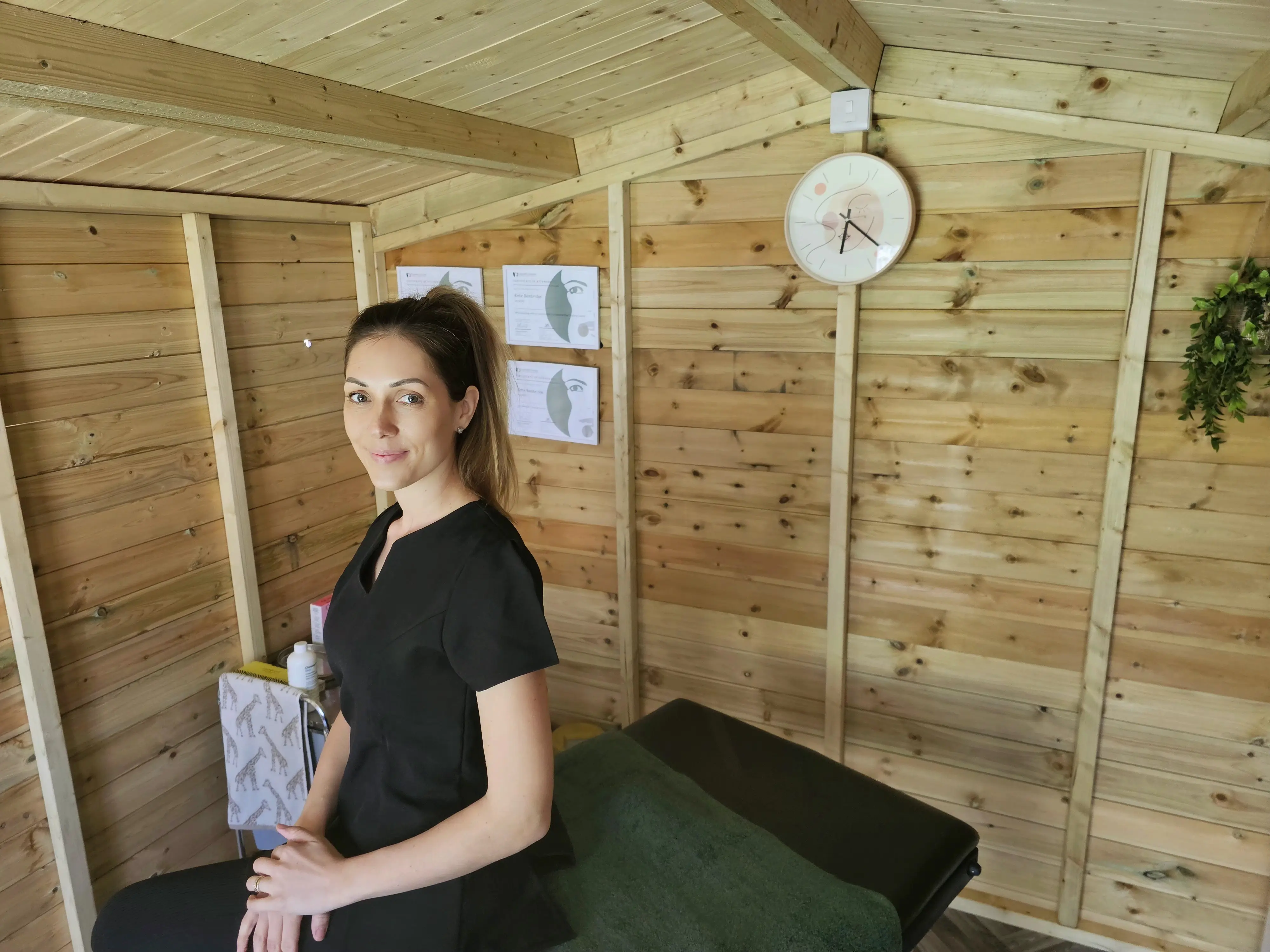 Therapist sat on clinic bed